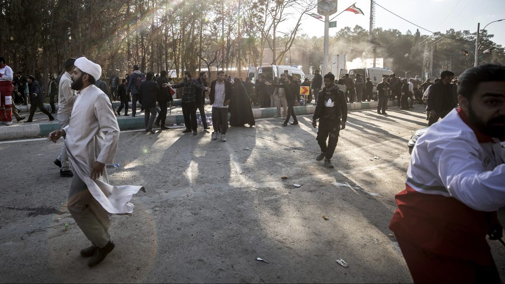 People are seen running after an explosion in Kerman, Iran, on Jan. 3, 2024