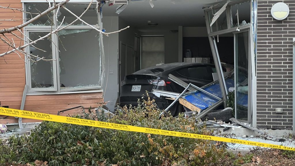 An investigation is underway after a Tesla crashed into the first floor of a home in a townhouse complex in North York.