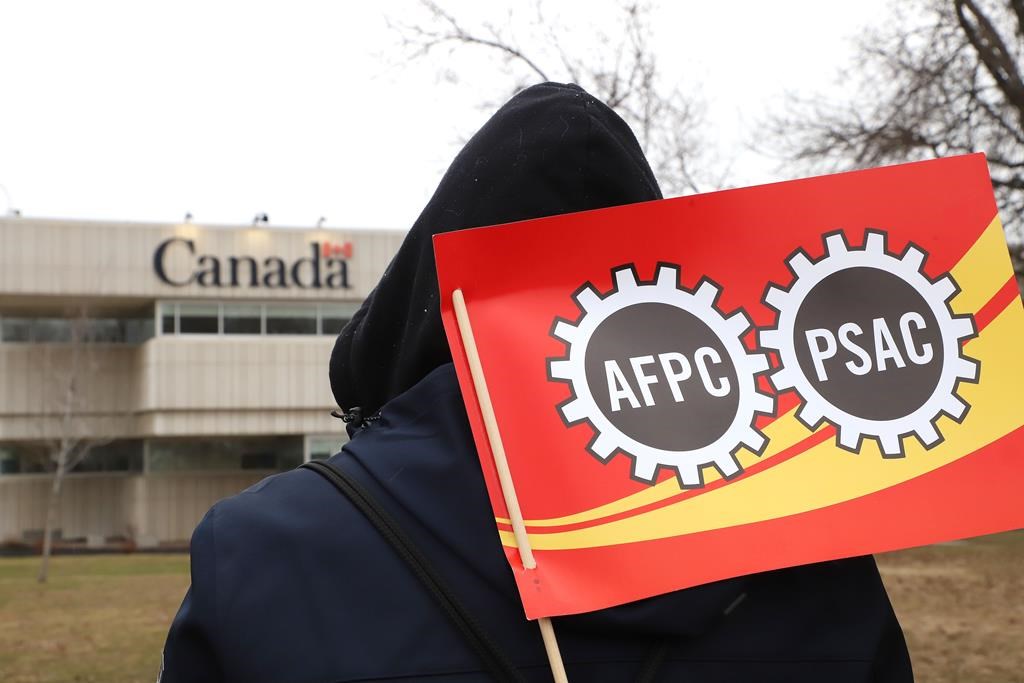 PSAC workers and supporters picket outside the Canada Revenue Agency office