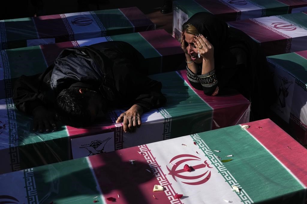 Iran mourns those slain in Islamic State-claimed suicide blasts as death toll rises to 89