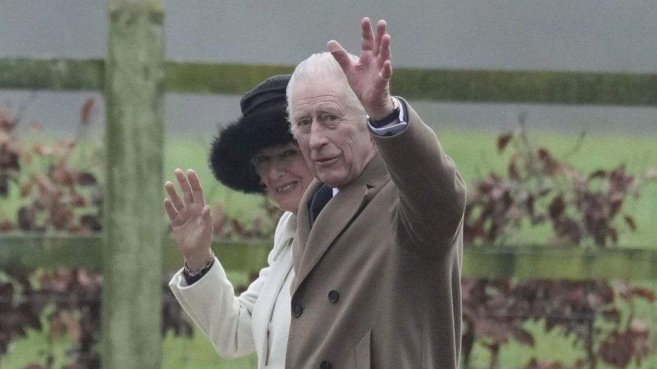 Britain's King Charles III and Queen Camilla wave to well wishers