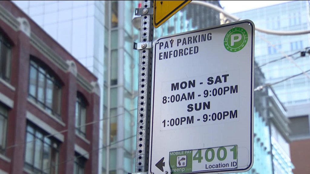 A sign showing paid on-street parking is being enforced