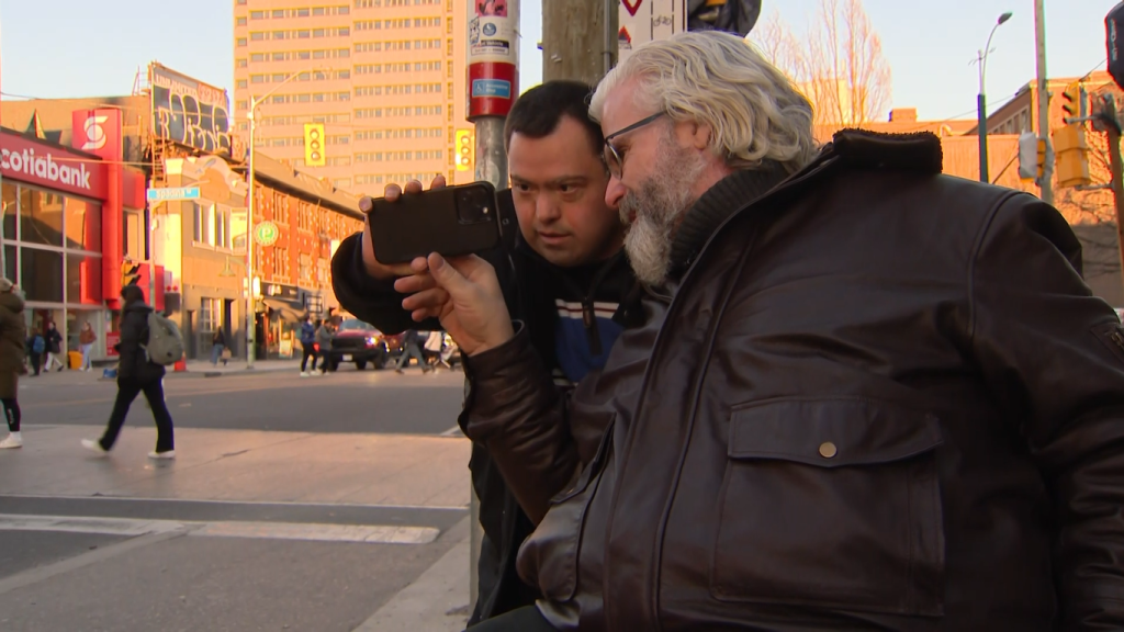 Disability Visibility Photography program participant Matthew Hoffman (pictured left) learns to take a photo with program instructor Steve Kean (pictured right). 