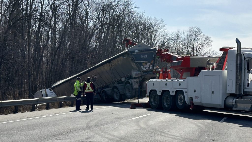 A heavy truck is being used to pull a transport truck out from a ditch on Highway 400 near Highway 88 on March 12, 2024