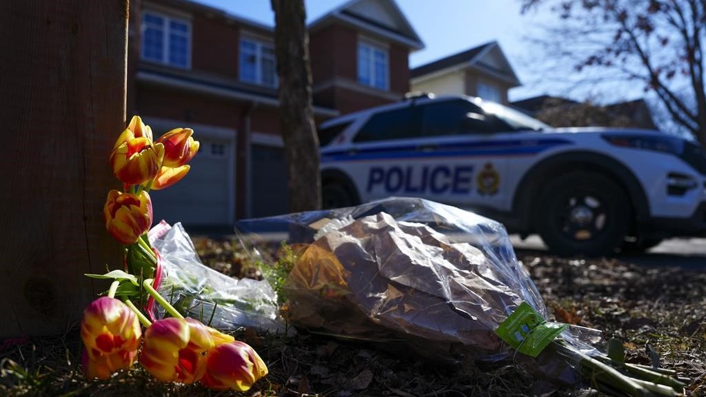 Flowers sit at the scene of a homicide where six people were found dead in the Barrhaven suburb of Ottawa on March 7, 2024