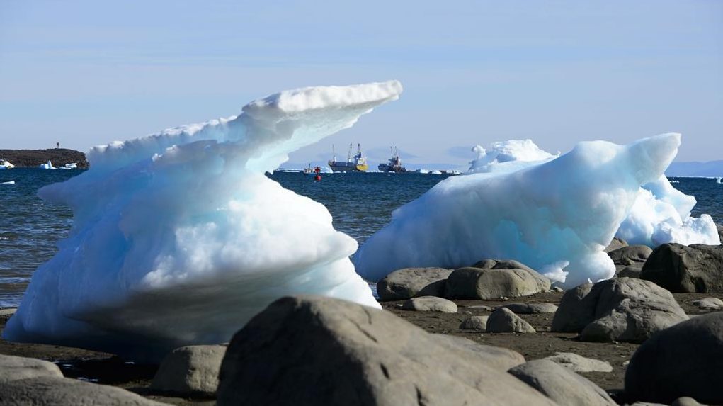 Ships are framed by pieces of melting sea ice in Frobisher Bay in Iqaluit, Nvt., on July 31, 2019