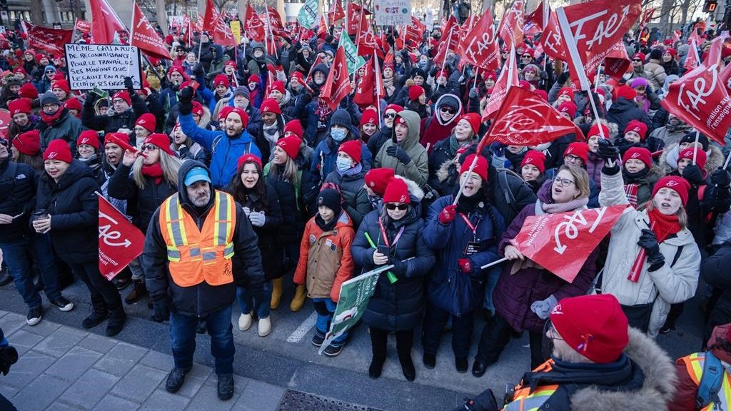 Striking teachers and their supporters hold a rally in front of Premier François Legault's office in Montreal on Dec. 22, 2023