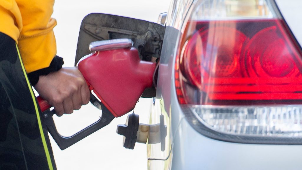 A motorist is seen filling up his car at the gas station.