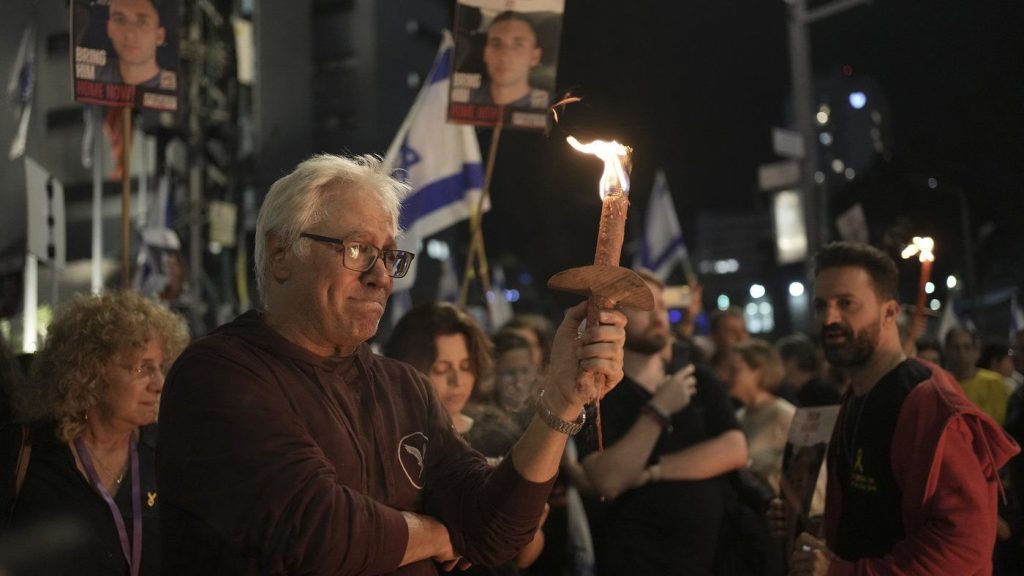 People take part in a protest against Israeli Prime Minister Benjamin Netanyahu's government