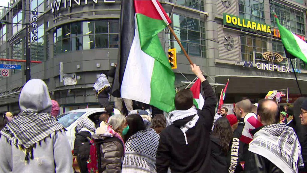 Demonstrators at a pro-Palestinian march and rally at Yonge-Dundas Square