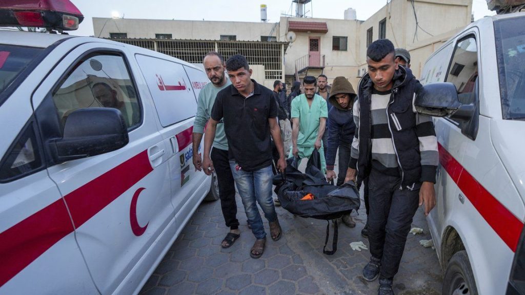 Palestinians carry the body of a World Central Kitchen worker