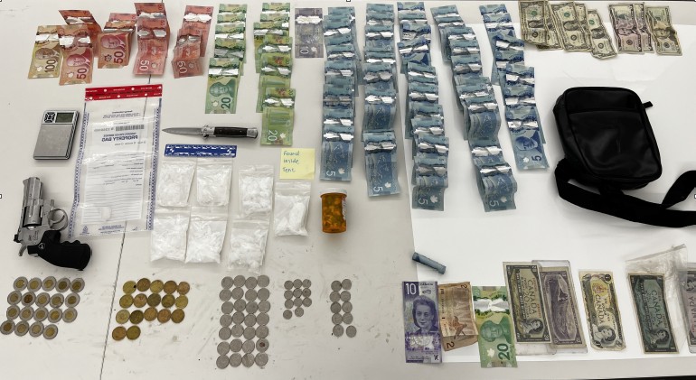 A quantity of drugs and a metal replica firearm were located in a tent in an encampment in Clarence Square Park. (Photo: Toronto Police Service)