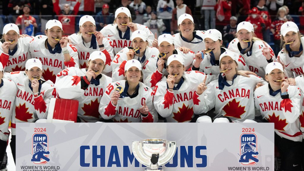 Canada players pose with their medals following their gold medal win over United States at the IIHF Women's World Hockey Championship in Utica, N.Y., Sunday, April 14, 2024.