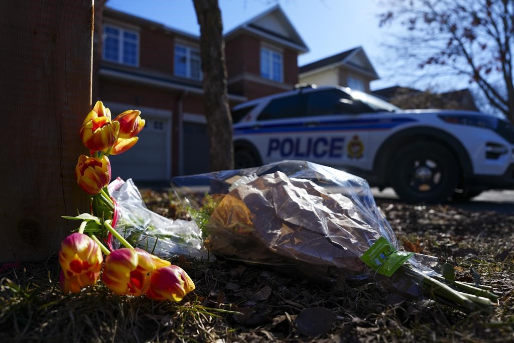 Flowers sit at the scene of a homicide where six people were found dead in the Barrhaven suburb of Ottawa