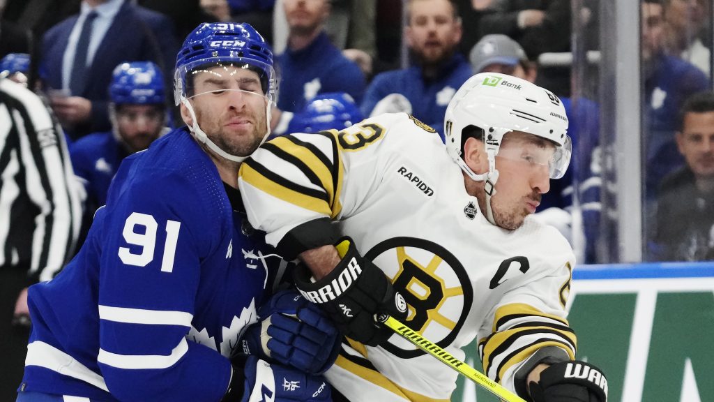 Toronto Maple Leafs' John Tavares (91) takes an elbow from Boston Bruins' Brad Marchand