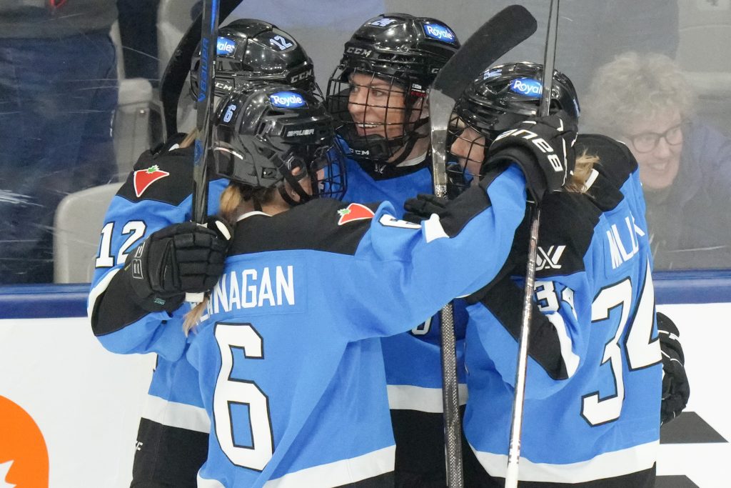 Toronto's Natalie Spooner celebrates with teammates after scoring against Minnesota