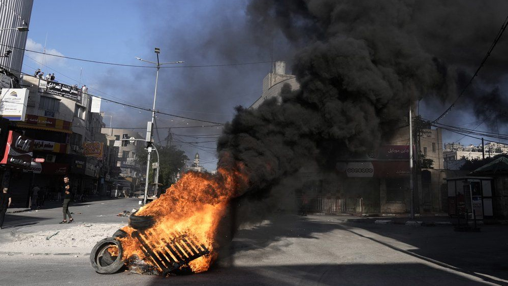 Tires burn as Israeli forces Israeli forces operate in the Balata refugee camp, in the West Bank city of Nablus