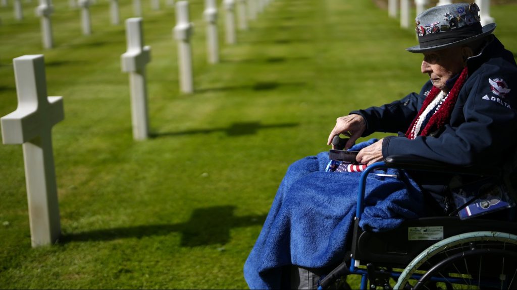 World War II and D-Day veteran Jake Larson visits the grave of a soldier from his unit at the Normandy American Cemetery in Colleville-sur-Mer, France, on June 4, 2024