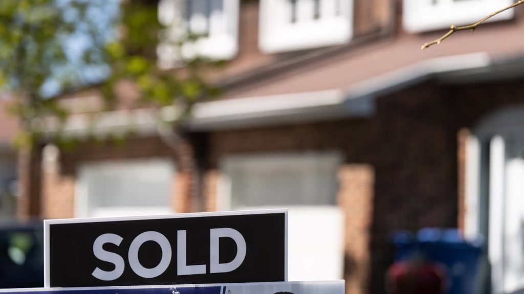 A real estate sign is posted outside a home in Pointe-Claire, a city in Montreal's West Island, on May 7, 2024