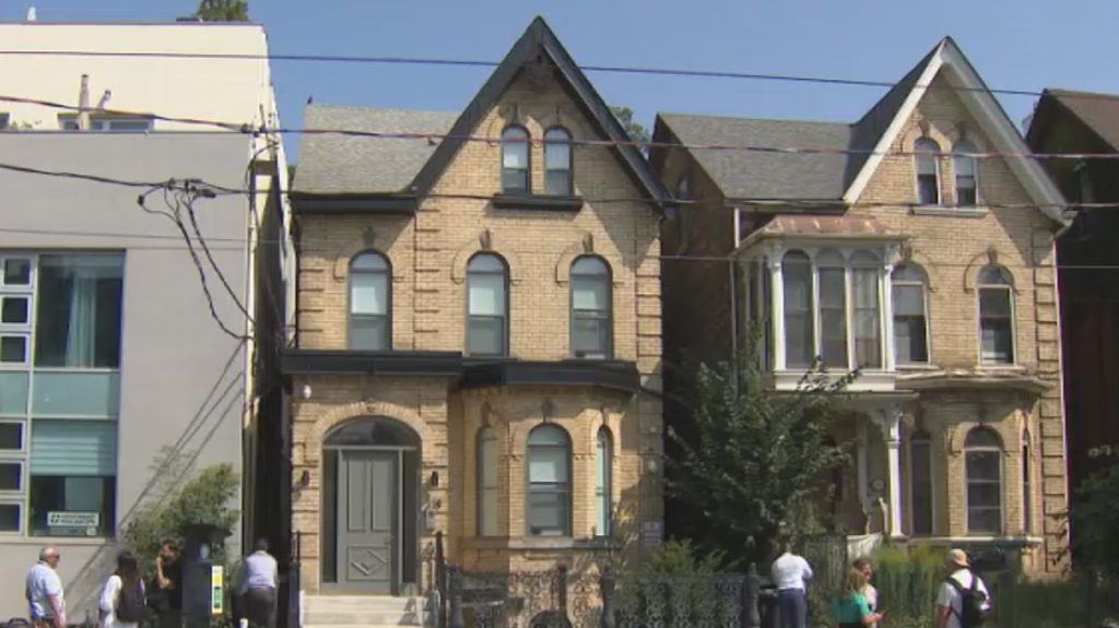 218 Carlton St. (centre) has been converted into affordable housing units for Indigenous men experiencing homelessnes