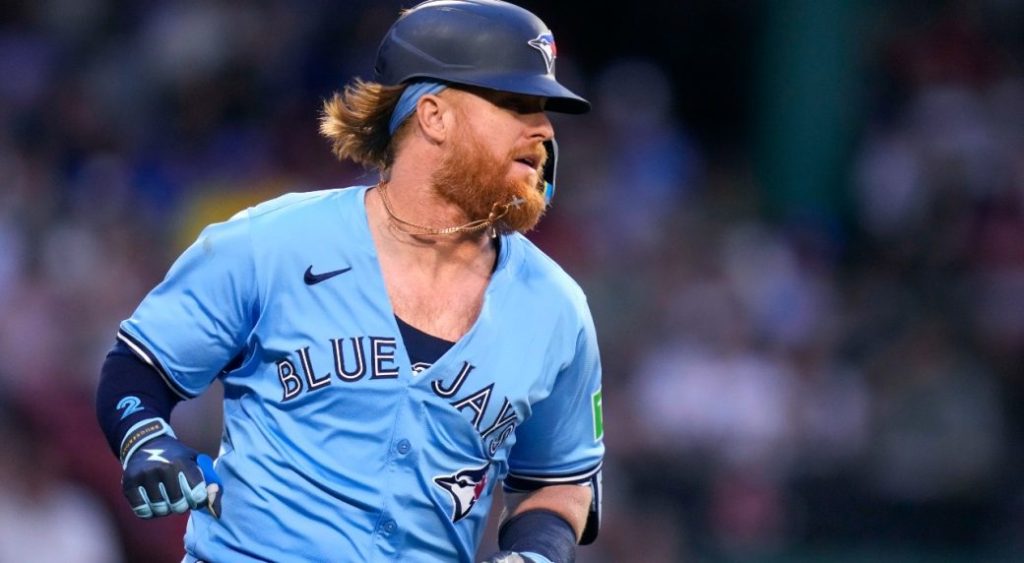 Toronto Blue Jays' Justin Turner dashes down the first base line on his RBI single during the fourth inning of a baseball game against the Boston Red Sox at Fenway Park, Monday, June 24, 2024, in Boston.