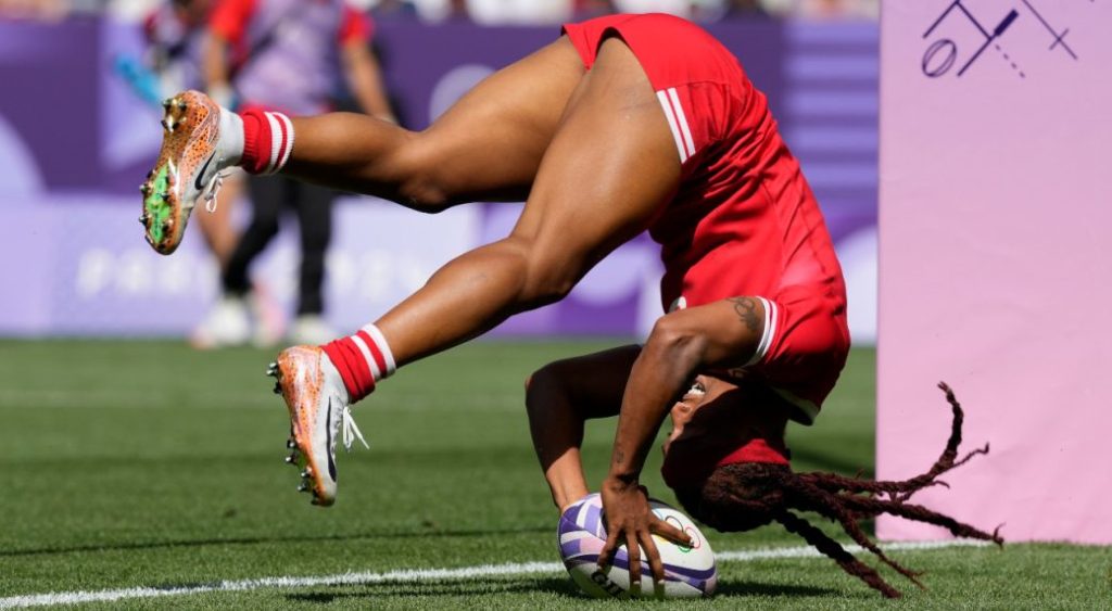 Canada's Charity Williams does a forward roll as she score a try during the women's Pool A Rugby Sevens match between Canada and China at the 2024 Summer Olympics, in the Stade de France, in Saint-Denis, France, Monday, July 29, 2024.