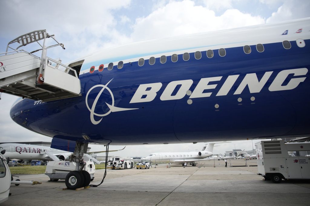 Boeing names its next CEO while posting a quarterly loss of more than $1.4 billion