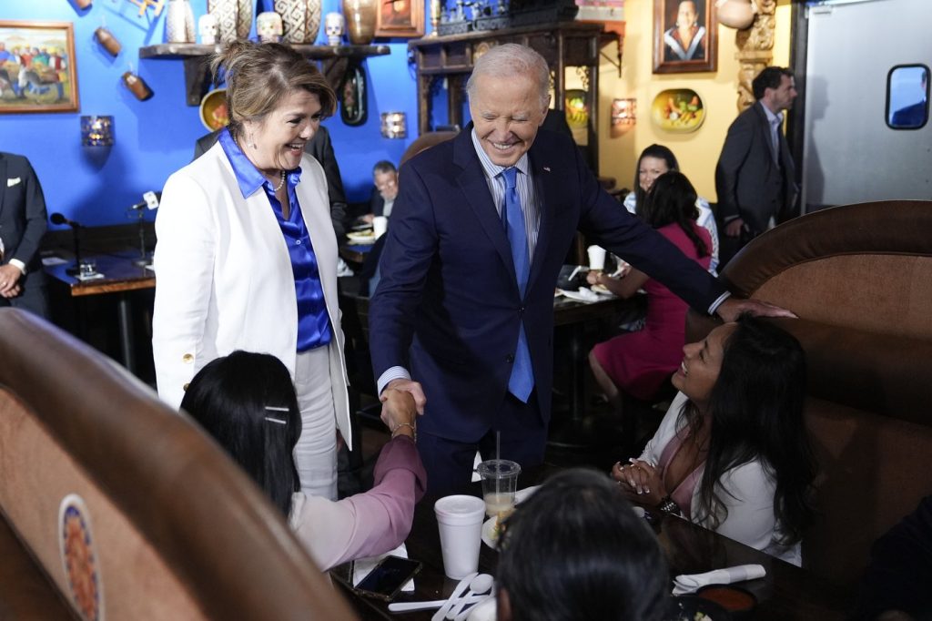 President Joe Biden and Maritza Rodriguez, Biden for President Latina adviser, greets patrons at Linda Michoacan Mexican Restaurant, during a stop in Las Vegas, Wednesday, July 17, 2024.