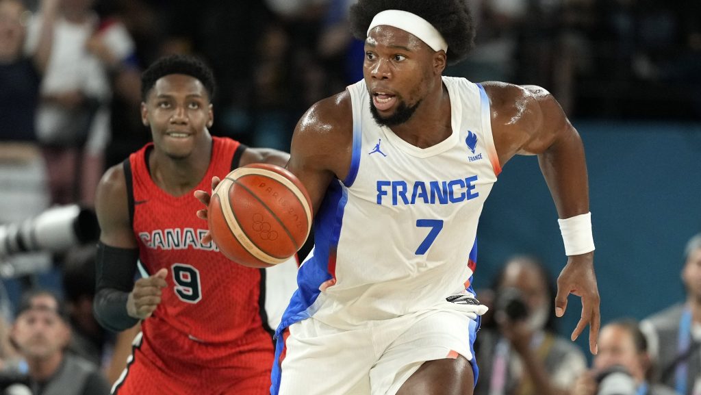 France's Guerschon Yabusele, right, drives the court followed by Canada's RJ Barrett during a men's quarterfinal game at Bercy Arena at the 2024 Summer Olympics in Paris, France, on Aug. 6, 2024