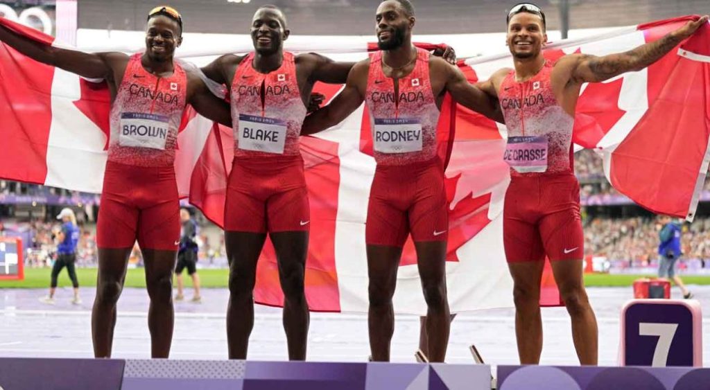 Team Canada pose after winning the gold medal in the men's 4 x 100 meters relay final