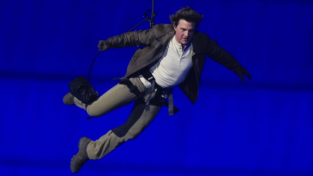 Tom Cruise is lowered on the State de France during the 2024 Summer Olympics closing ceremony, Sunday, Aug. 11, 2024, in Saint-Denis, France. (AP Photo/Natacha Pisarenko)