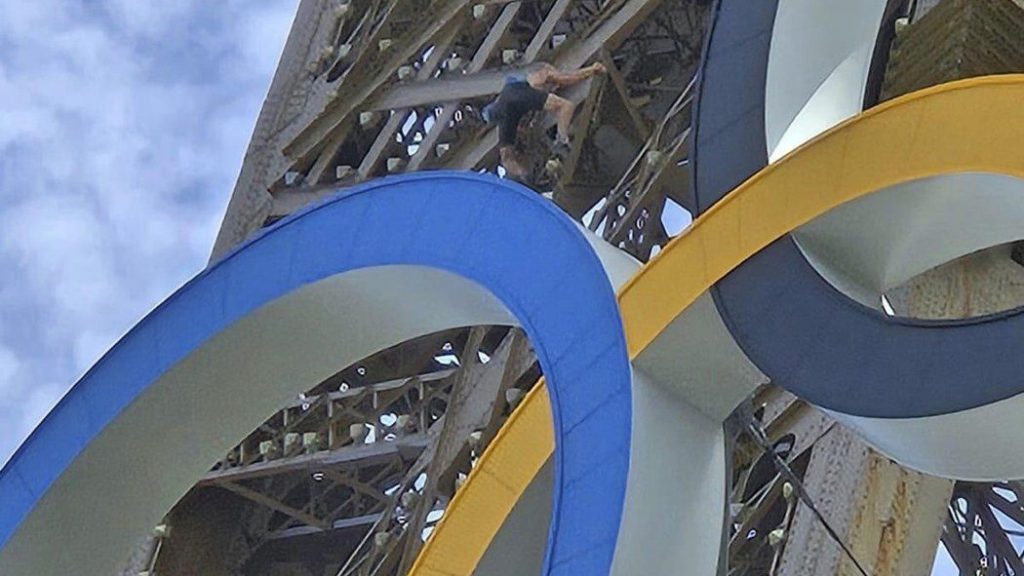 A man climbs the Eiffel Tower