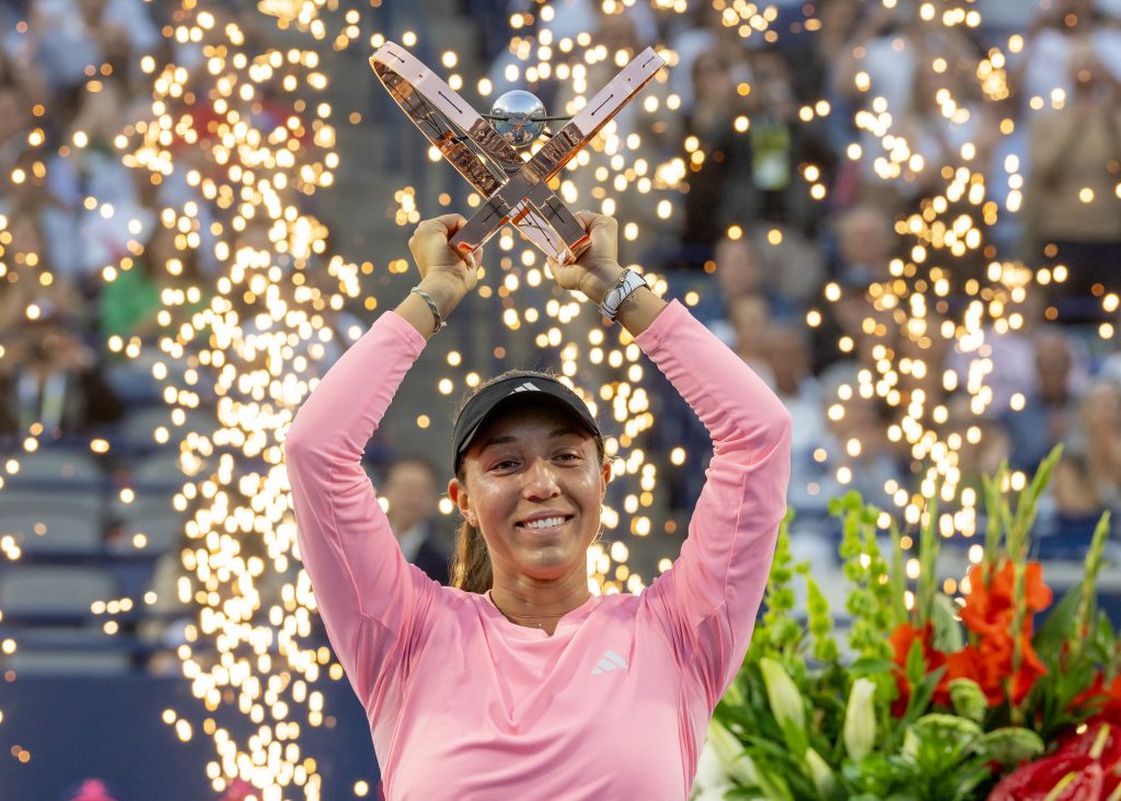 Jessica Pegula, of the United States, raises her trophy as she celebrates her women's singles final win over Amanda Anisimova, of the United States, at the National Bank Open, in Toronto, Monday, Aug. 12, 2024.