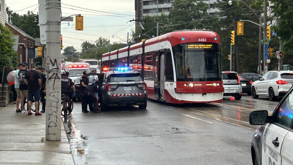 Toronto police on scene after a car collides with a TTC streetcar and another vehicle.