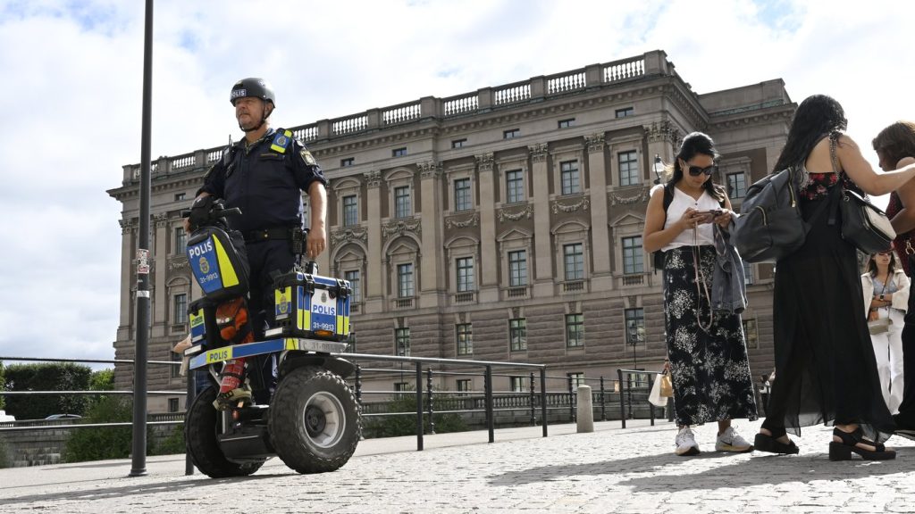 FILE - A police officer on a Segway patrols Sweden's parliament in Stockholm on Aug. 17, 2023