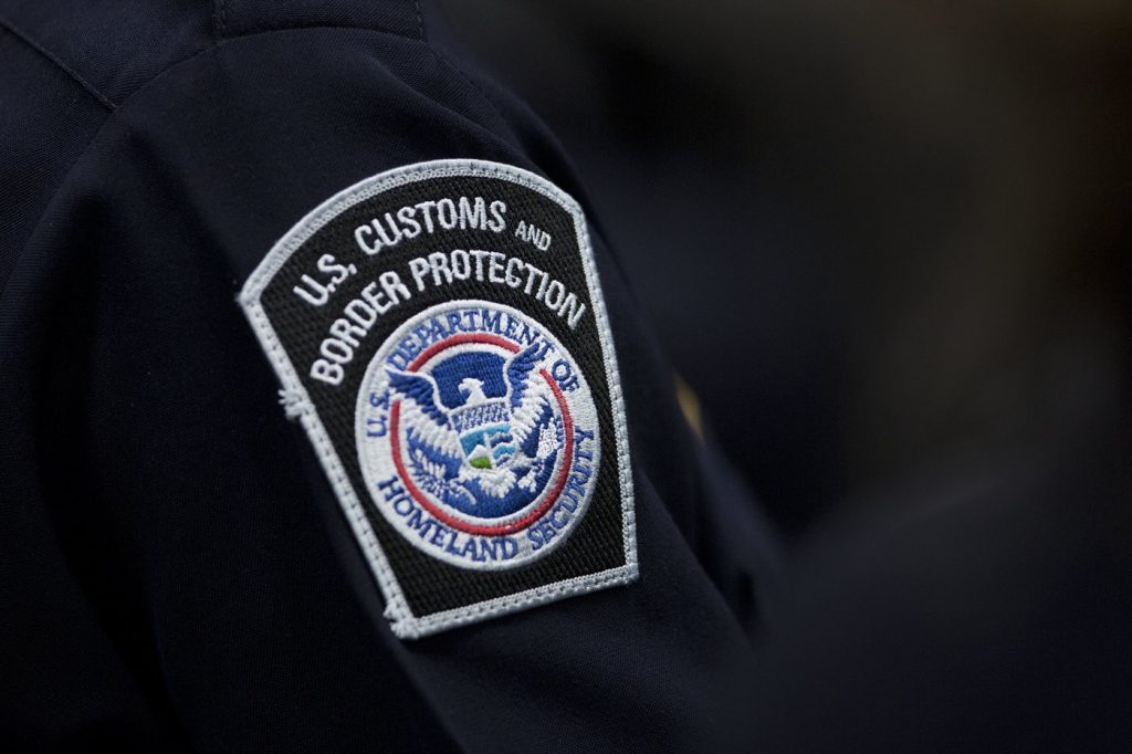 A customs agent wears a patch for the U.S. Customs and Border Protection agency