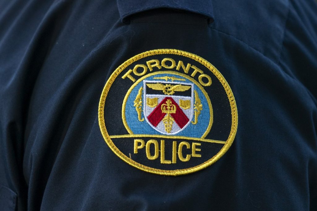 A Toronto Police Service logo patch is shown in Toronto, on Tuesday, Sept. 5, 2023. Toronto police say they've charged a 22-year-old woman with first-degree murder after human remains and chemicals were allegedly found in an apartment in June. THE CANADIAN PRESS/Spencer Colby