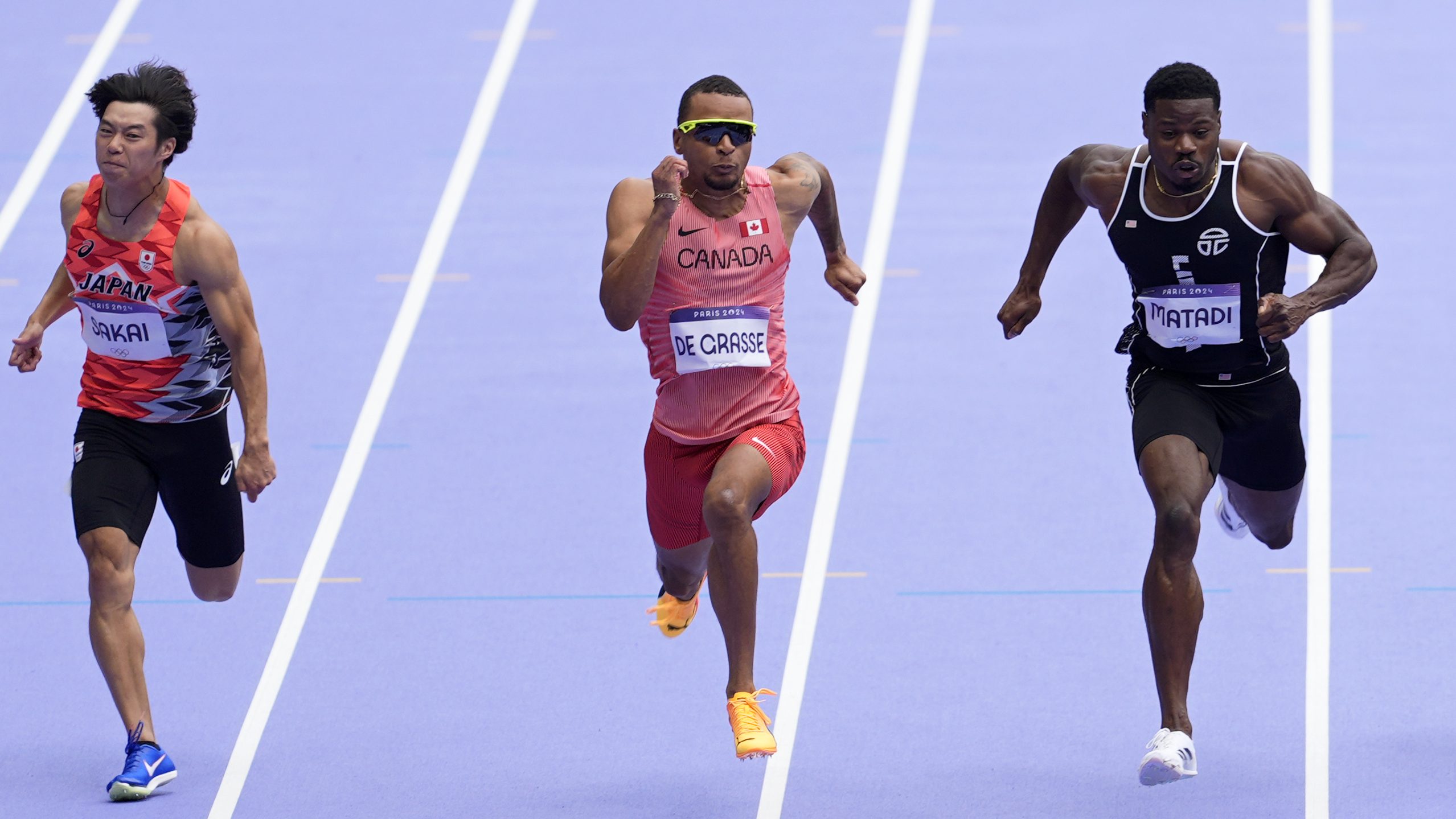 Andre de Grasse, of Canada, crosses the finish line to qualify in a men's 100 meters round 1 heat at the 2024 Summer Olympics, Saturday, Aug. 3, 2024, in Saint-Denis, France.