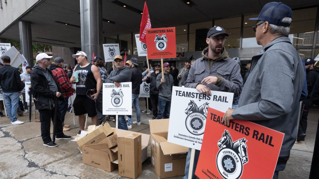 Rail workers picket in front of CN headquarters on the first day of a nationwide rail shutdown in Montreal on Aug. 22, 2024