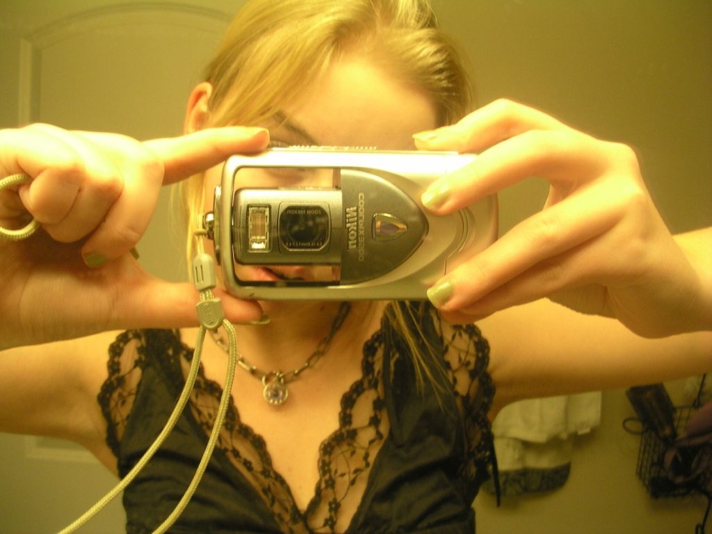 Anya Chigak poses for a photo using an older digital camera in this 2022 handout photo