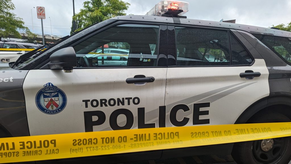 A Toronto Police Services cruiser is seen behind yellow tape