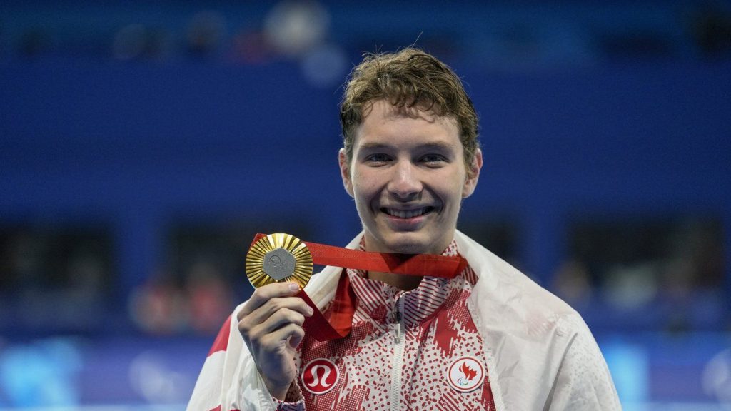 Canada's Nicholas Bennett poses with his gold medal