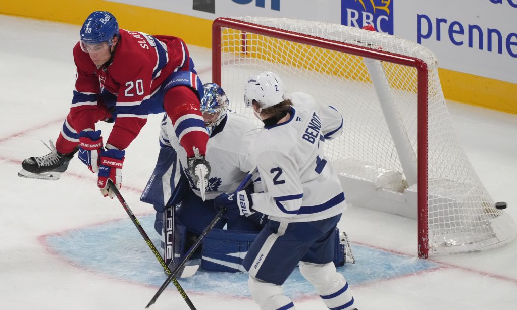 Montreal Canadiens' Juraj Slafkovsky tries to screen a shot on Toronto Maple Leafs goaltender Anthony Stolarz