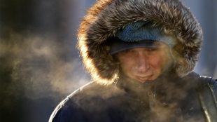 A man in a parka is seen in cold winter weather