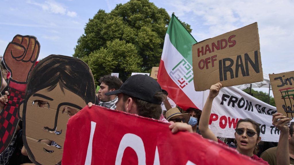 A woman holds a placard during a demonstration ahead of the NATO summit in The Hague, Netherlands, Sunday, June 22, 2025. (AP Photo/Peter Dejong) 
