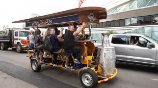 Fans ride a pedal pub in front of Rogers Place as the Edmonton Oilers take on the Florida Panthers in game 6 action of the NHL Stanley Cup finals in Edmonton on June 21, 2024