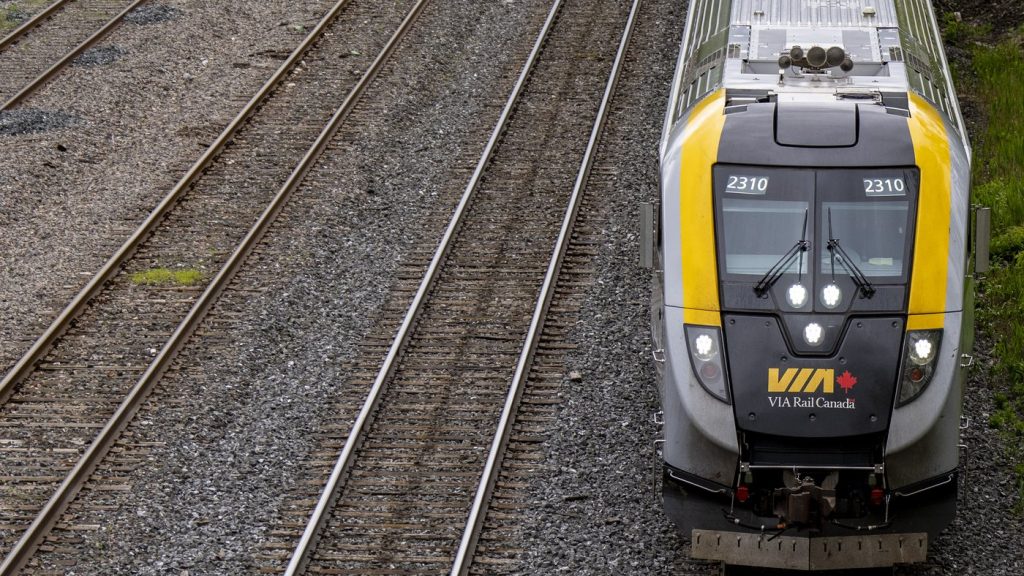 A Via Rail train is seen on tracks in Dorval, Que., as it heads out of Montreal on May 23, 2025. THE CANADIAN PRESS/Christinne Muschi