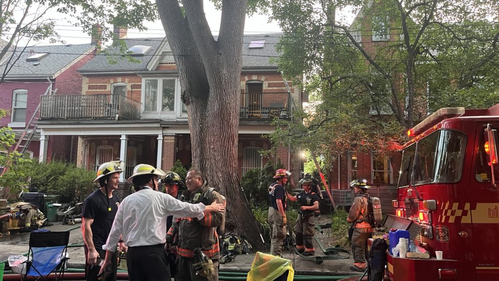 Photo shows fire crews at the scene of a blaze on College Street. (Karim Islam/CityNews)