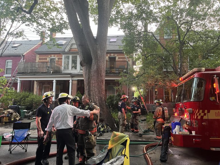 Photo shows fire crews at the scene of a blaze on College Street. (Karim Islam/CityNews)
