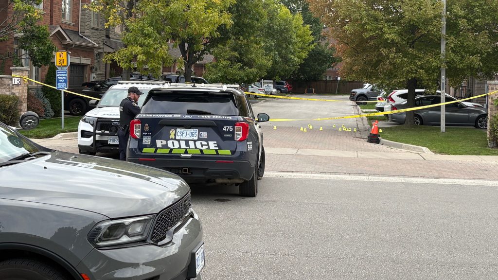 Shell casing markers are seen on the ground outside a home in the area of Pottery Place and Blue Willow Drive in Vaughan